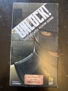 Unlock!: The Escape Room Game – In Pursuit of the Iron Mask board game cover